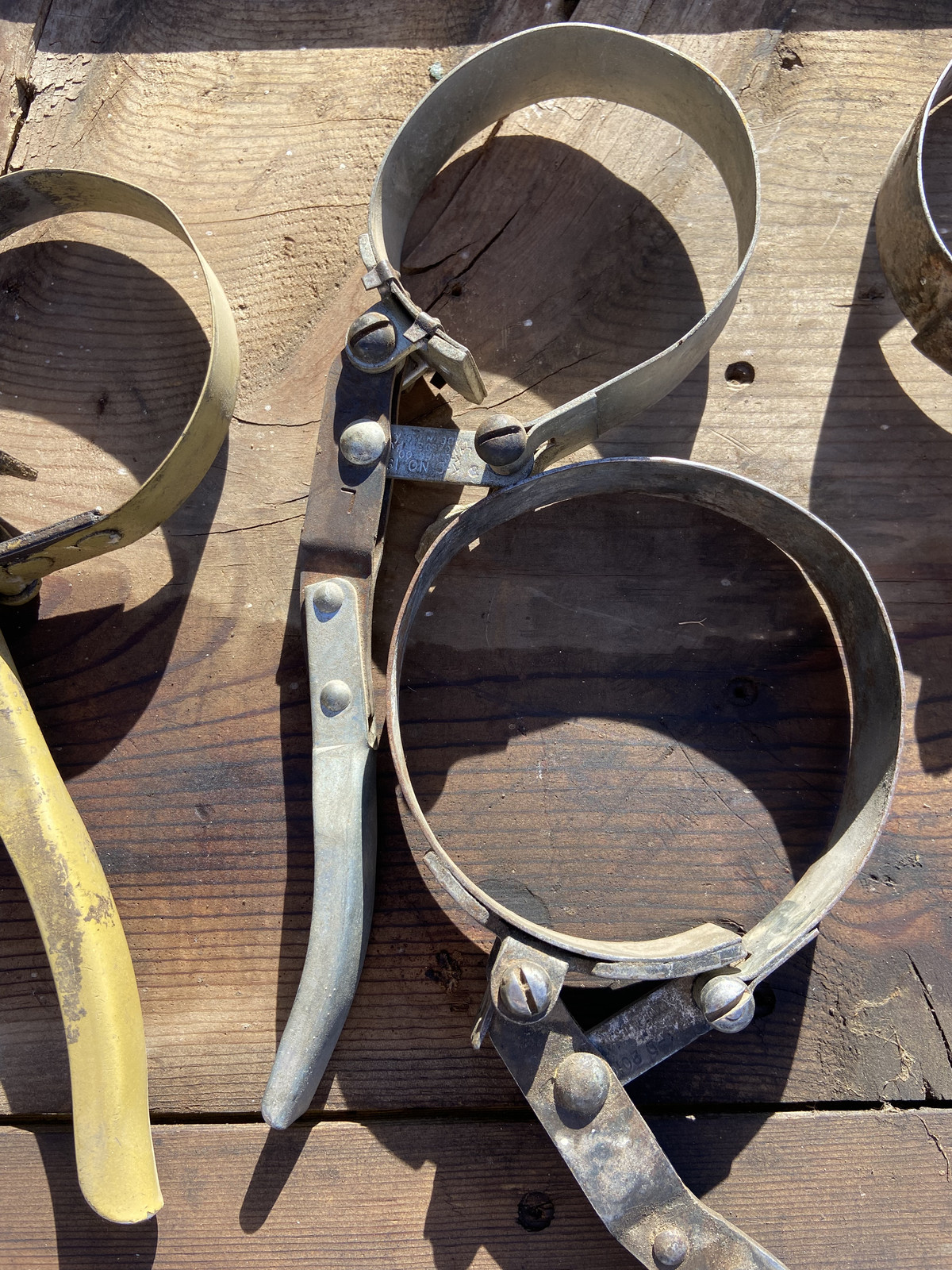 Vintage collection of 5 oil filter wrenches and a chain tool
