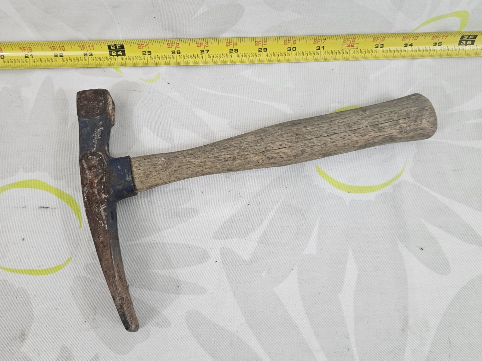 vintage masonry brick hammer with a wooden handle