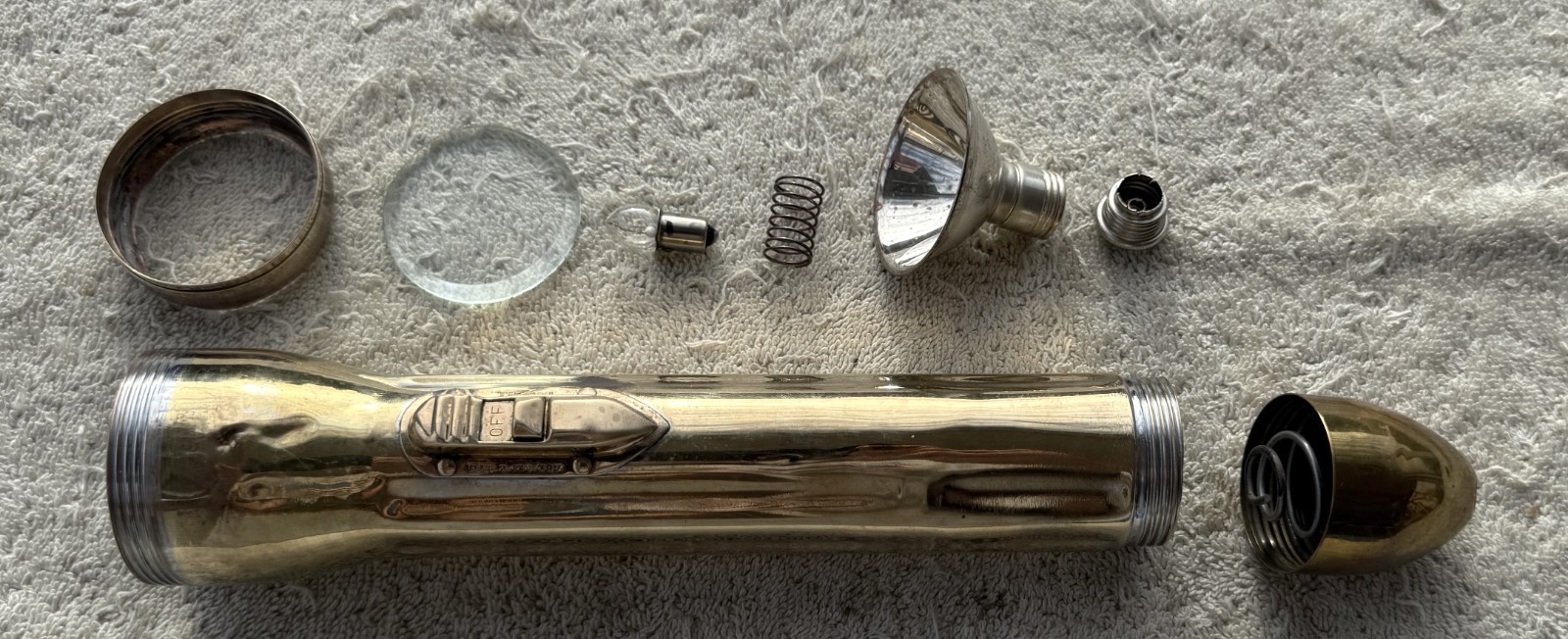 VINTAGE CIRCA 1930’S “BULLET” FLASHLIGHT, WORN TO BRASS FINISH – GLASS LEN