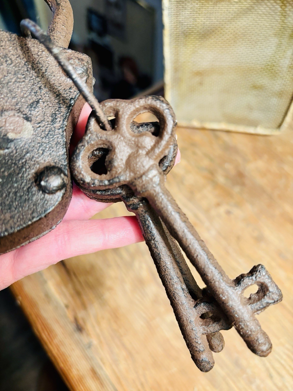 Vintage cast iron padlock with three skeleton keys on a ring.