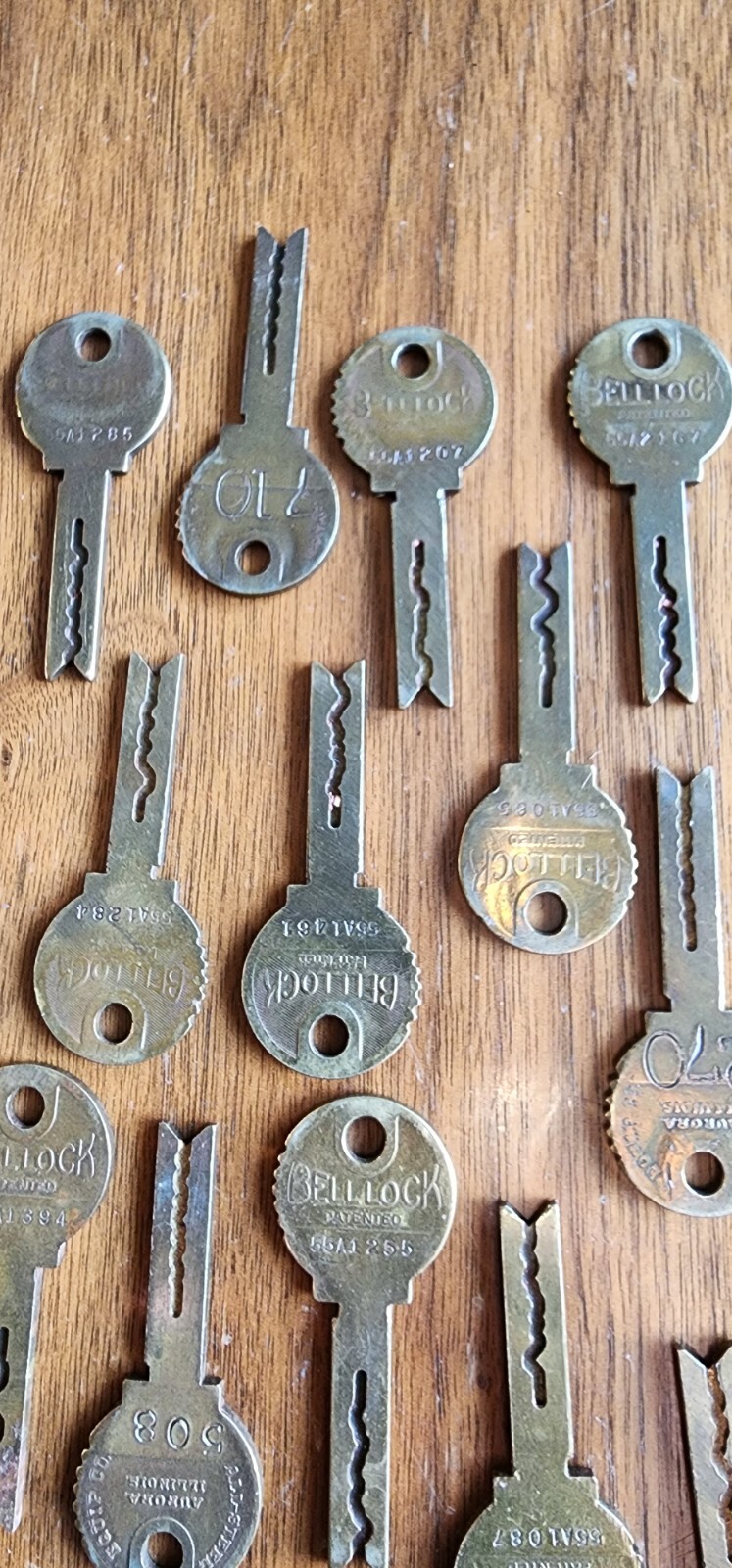 Twenty One Vintage BELL LOCK Keys Brass 2 1/4″ Long. Stamped Aurora Illinois