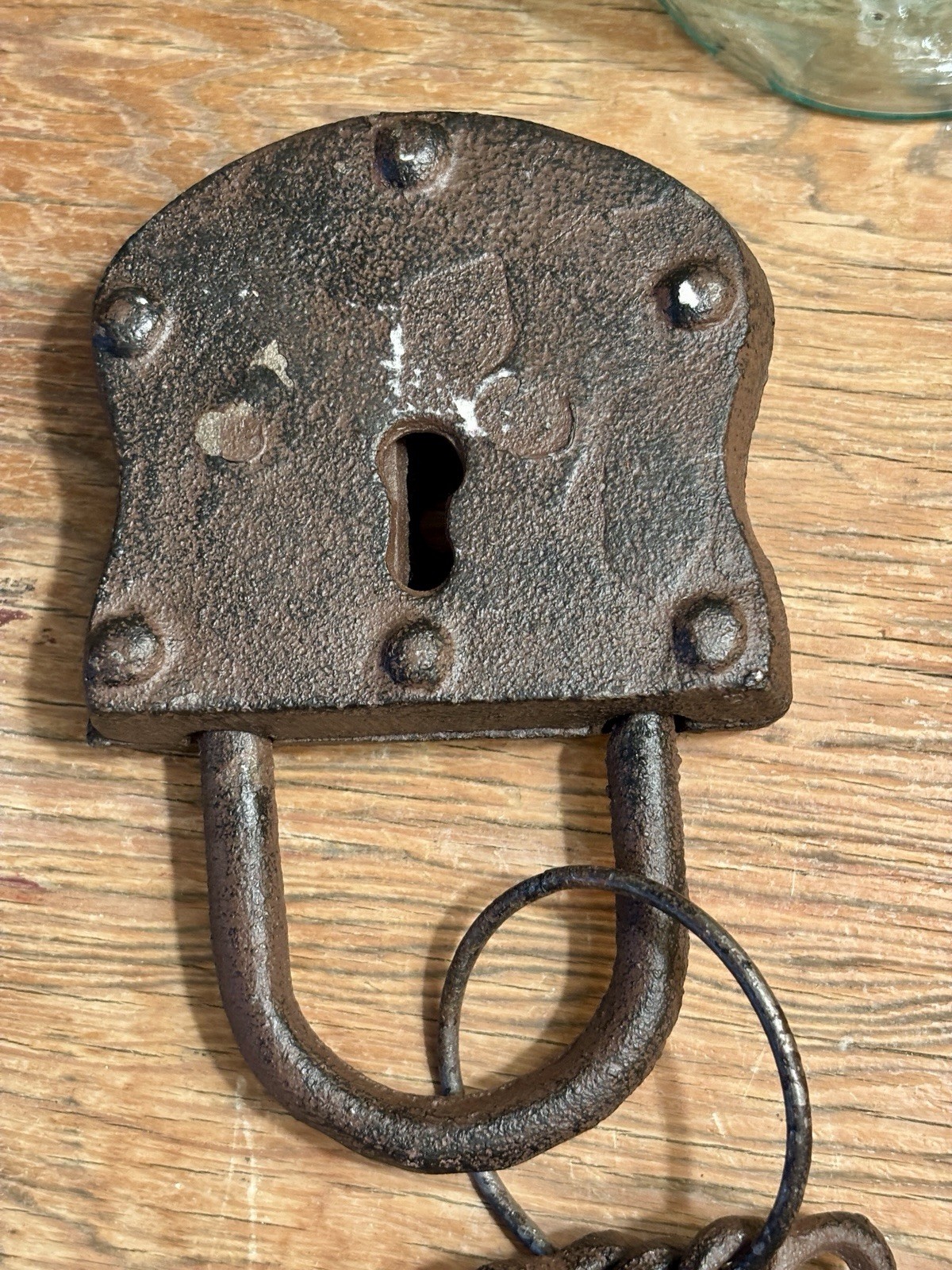 Vintage cast iron padlock with three skeleton keys on a ring.