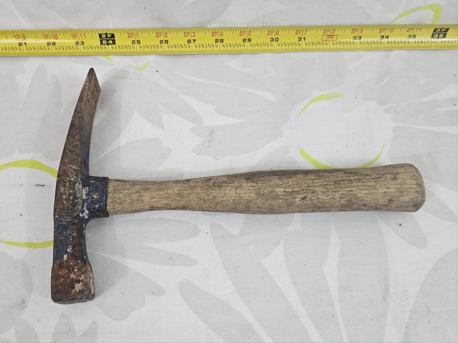 vintage masonry brick hammer with a wooden handle
