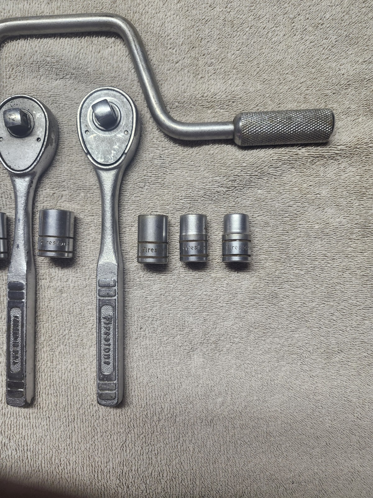 GROUP OF 12 FIRESTONE 1/2″ DR HAND TOOLS. 9 SOCKETS 1 SPEED WRENCH & 2 RATCHETS