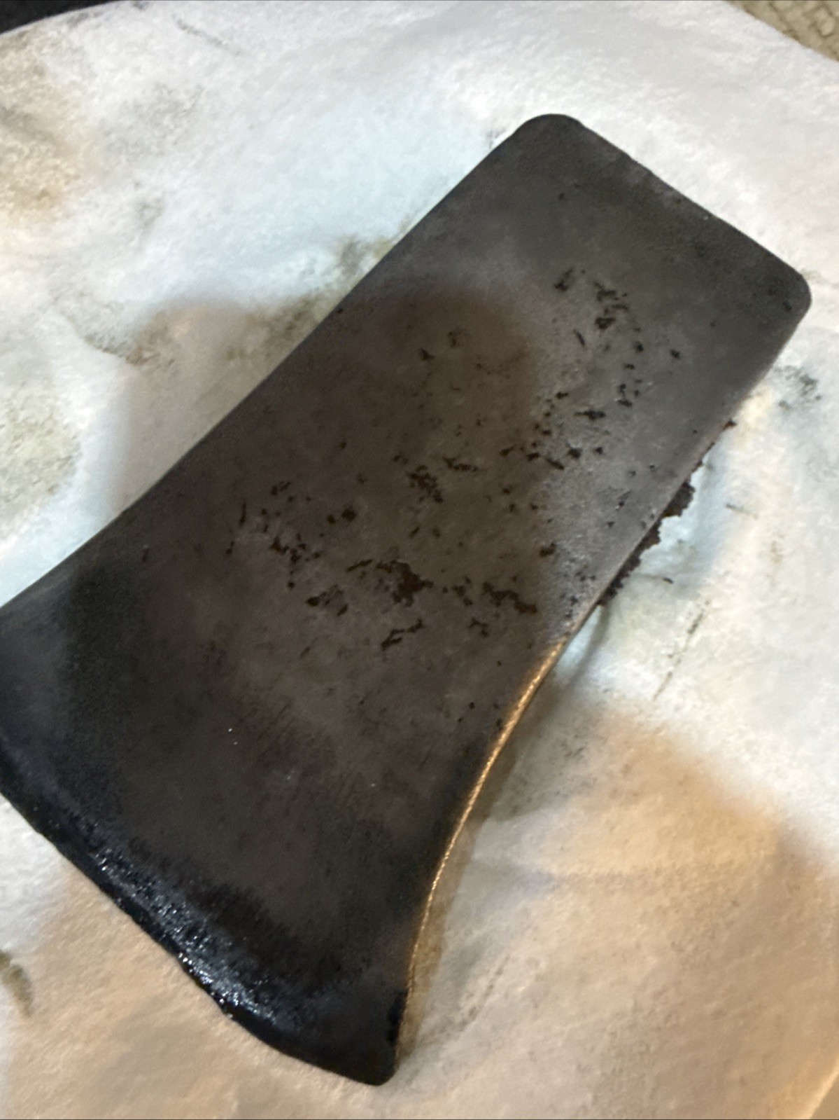 This vintage single-bit axe head By Mann Edge Tool Co.