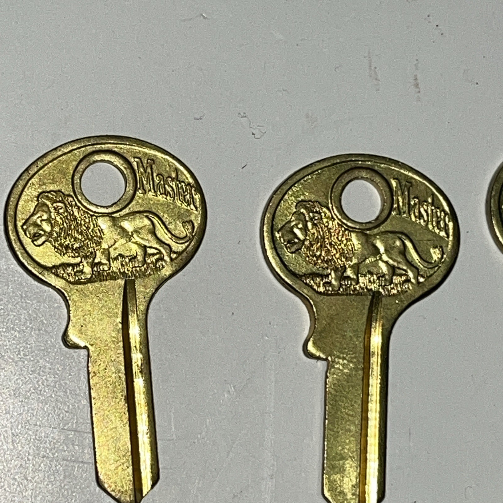 One Dozen Master Padlock Keys, Uncut, Blanks, All Brass, All Walking Lions