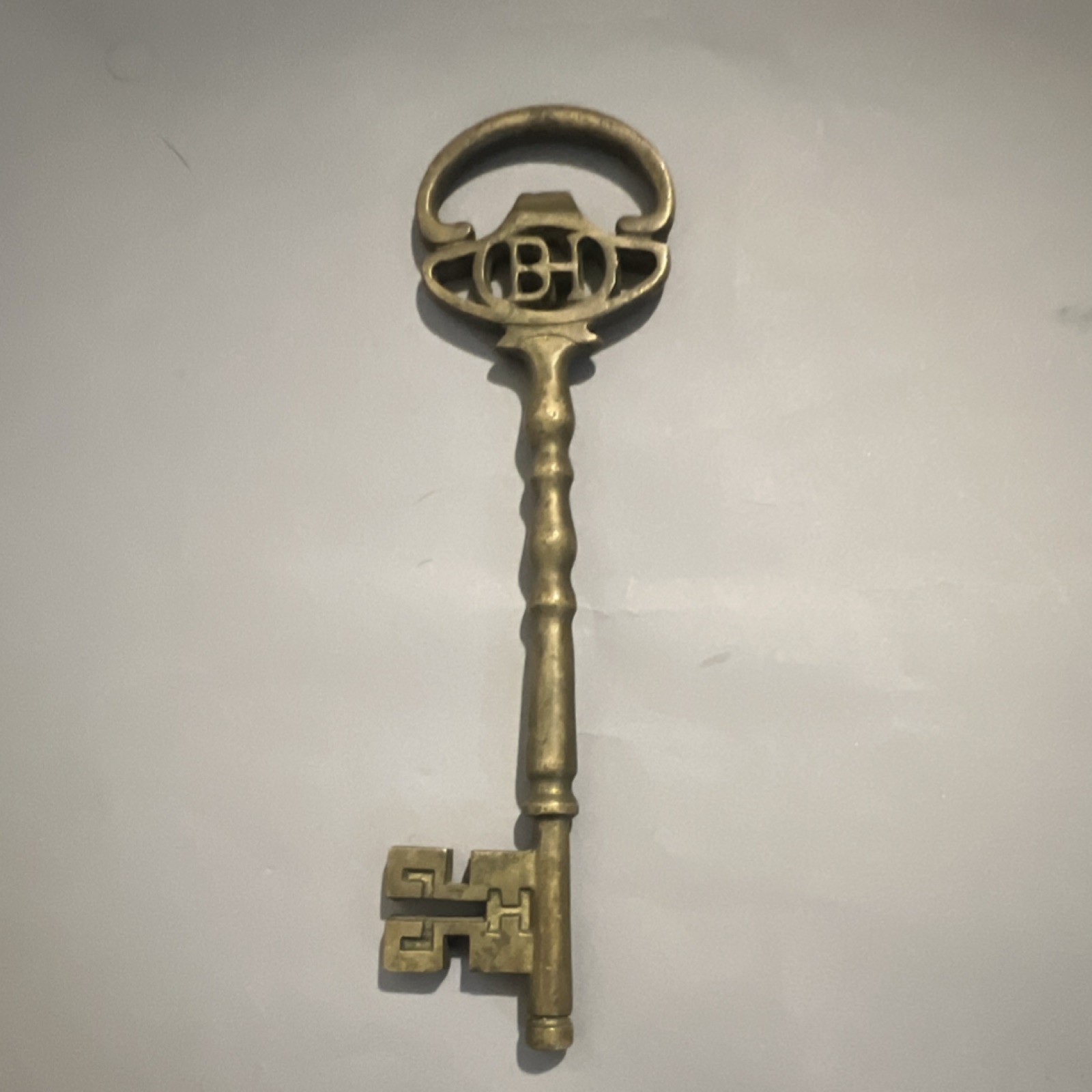 Antique Style Brass Tone Skeleton Key with Ornate Bow, “BD” Monogram Top