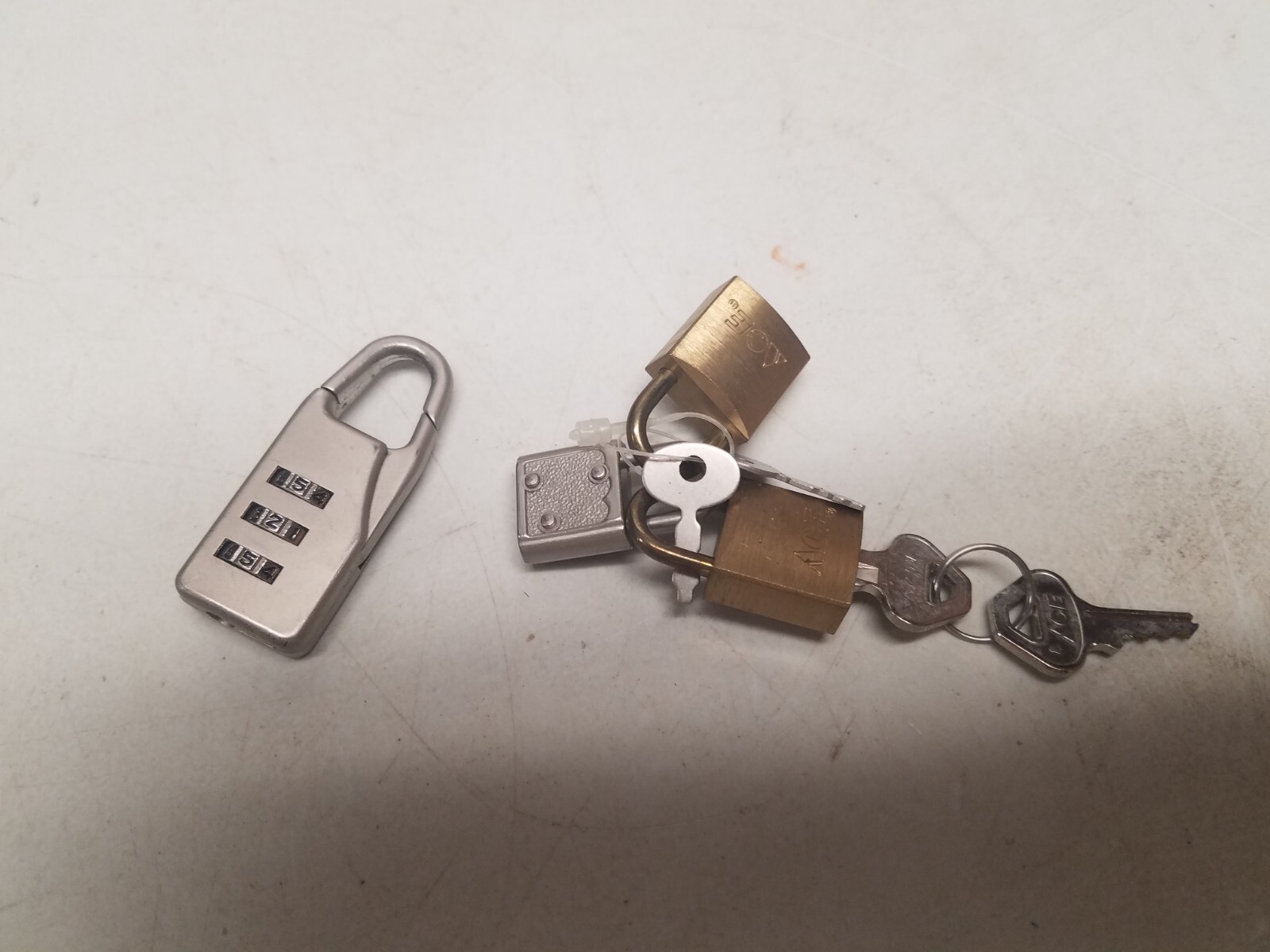 4 small Pad-a-locks, 3 Keyed, 1 Combination