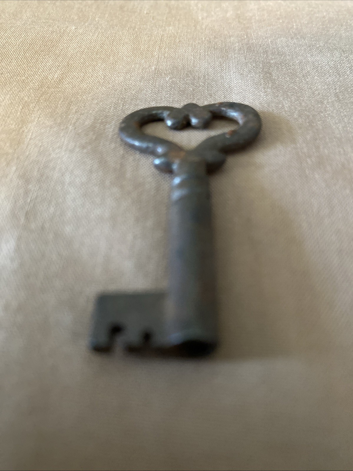 Vintage hollow steel key with heart shaped bow