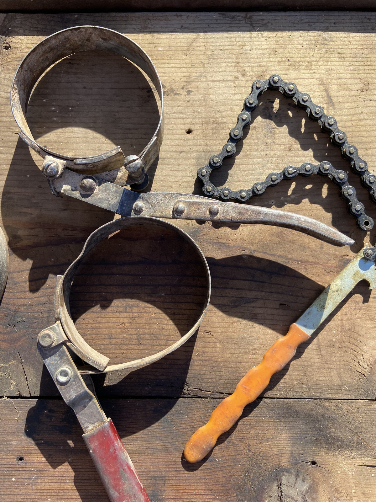 Vintage collection of 5 oil filter wrenches and a chain tool